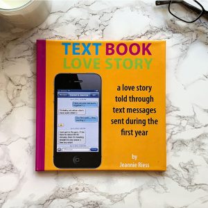 flat lay of a book with title "Text Book Love Story" on a marble table